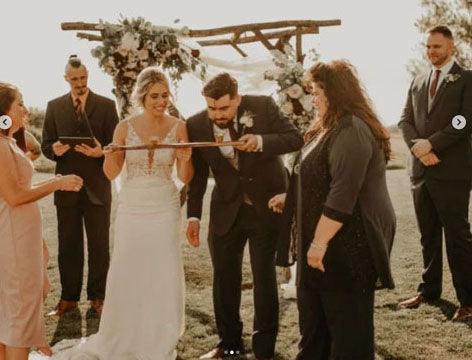 bride and groom holding a shot ski