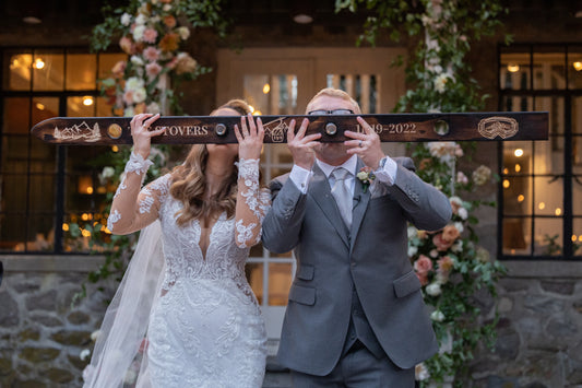 bride and groom drinking from a shot ski